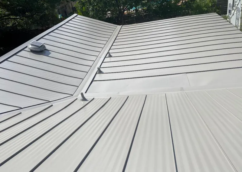 Solar attic fan installed on a metal roof for Roof Ventilation in Elwood